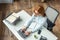 Overhead of redhead businesswoman typing on