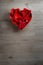 Overhead of Rose Petals in Heart Shaped Bowl on Wood