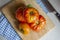 Overhead selective shot of tomatoes stacked on each other on a wooden chopping board