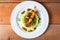 overhead shot of bangers and mash with peas on a plate