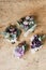 Overhead shot of beautiful bouquets of purple flowers on a wooden surface