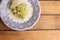 Overhead shot of boiled Romanesco broccoli and potato in a decorative plate on a wooden table