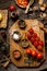 Overhead shot of branch ripe cherry tomatoes on wooden board