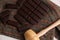 Overhead shot of dark chocolate bars on a napkin with a small wooden hammer on a table