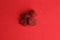 Overhead shot of dried strawberry candies on a red background