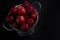 Overhead shot of fresh red apples in a bucket isolated on a black background