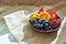 Overhead shot of a full plate of juicy, sliced fruits on wooden plate