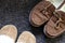 Overhead shot of generic ladies and mens slippers on a dark gray