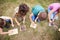 Overhead Shot Of Group Of Children On Outdoor Camping Trip Learning How To Make Fire