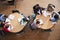 Overhead Shot Of High School Pupils In Group Study Around Tables