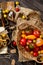 Overhead shot of homegrown assorted red, yellow, orange tomatoes in wicker straw basket