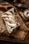 Overhead shot of homemade banana shaped cookies in wooden basket on rustic brown table