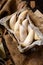 Overhead shot of homemade banana shaped cookies in wooden basket on rustic brown table