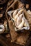 Overhead shot of homemade banana shaped cookies in wooden basket on rustic brown table