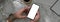 Overhead shot of male entrepreneur using blank screen smartphone to relax at marble worktable