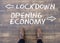 Overhead shot of a man standing in front of a sign Lockdown, Opening Economy on wood