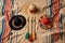 overhead shot of maracas, sombrero and mexican poncho on a sandy beach