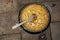 Overhead shot of a pan of paella cooking outdoors