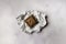 Overhead shot of a single chocolate block on a piece of foil on a marble surface