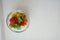 Overhead shot of slices of colorful bell peppers in a glass bowl