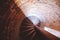 Overhead shot of a spiral staircase in a brick tower