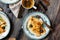 Overhead shot of thin yummy crepes with honey, blueberries on three vintage plates