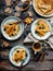Overhead shot of thin yummy crepes with honey, blueberries on three vintage plates