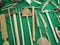 Overhead shot of various wooden gardening tools displayed on green textile