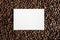 Overhead shot of a white rectangle in the middle of coffee beans great for writing text