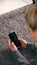 Overhead Shot Of Woman Looking At Screen With Copy Space On Mobile Phone Lying On Carpet