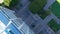 Overhead tilt aerial footage of rooftop pool area surrounded by skyscrapers, office buildings in the city skyline in Los Angeles