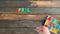 Overhead time lapse video of a child`s hand spelling out an April Fools Day message in colored block letters on a wooden