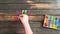 Overhead time lapse video of a child`s hand spelling out a Happy Fathers Day  message in colored block letters on a wooden