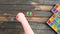 Overhead time lapse video of a child`s hand spelling out Happy Thanksgiving message in colored block letters on a wooden