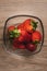 Overhead vertical shot of strawberries in a glass bowl on a wooden background