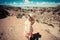 Overhead view of an active blonde woman headed out for a hike in Canyonlands National Park in Utah. Artistic filter applied