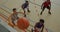 Overhead view of african american male basketball player scoring goal against diverse players