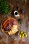 Overhead view of aperitif table Meat snack, fried sausages, cheese, salami, olives and a glass of wine on a dark table Menu and re