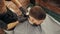 Overhead view of barber trimming hair of male client in barber shop