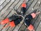 Overhead view of black and red lobster buoys on a dock tied together with rope in a fishing village on Mt Desert Island on the