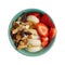 Overhead view of a bowl with plain Greek yogurt candy trail mix bananas and strawberries isolated on a white background