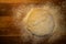 Overhead view of bread dough ball on a wooden cutting board with flour Copyspace