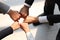 Overhead view of businessman and woman putting hands first join together, business partnership colleagues holding hands as