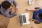 Overhead View Of Businesspeople Using Laptop In Office