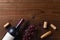 Overhead view of a Cabernet Sauvignon wine bottle on a dark wood surface with grapes and cork screw corks and copy space