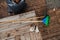 An overhead view captures a set of garden maintenance tools, including a broom, bucket, rake, and shovel, essential for