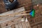 An overhead view captures a set of garden maintenance tools, including a broom, bucket, rake, and shovel, essential for