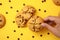 Overhead view captures sweet cookies breaking on a yellow background