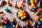 An overhead view capturing the festive arrangement of birthday balloons and party hats. Colorful balloons,