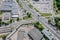 Overhead view of city crossroad near shopping mall and parking lot with cars